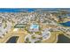 Beautiful aerial view showcases the community pool, tennis courts, and well-maintained landscaping near the lake at 15241 Sunrise Grove Ct, Winter Garden, FL 34787