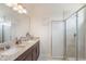 Bathroom featuring double sinks, granite counters, and a glass enclosed shower at 15241 Sunrise Grove Ct, Winter Garden, FL 34787