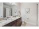 Modern bathroom with dual sinks, granite countertops, and a spacious shower and bath area at 15241 Sunrise Grove Ct, Winter Garden, FL 34787