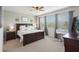 Serene bedroom featuring a king-sized bed, large windows, and soothing neutral tones at 15241 Sunrise Grove Ct, Winter Garden, FL 34787