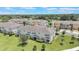 Beautiful aerial view of townhomes with manicured lawns and mature trees on a bright sunny day at 15241 Sunrise Grove Ct, Winter Garden, FL 34787