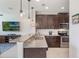 Modern kitchen featuring granite countertops, stainless steel appliances, and dark wood cabinets at 15241 Sunrise Grove Ct, Winter Garden, FL 34787