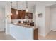 Stylish kitchen with granite countertops, dark wood cabinets, and pendant lighting at 15241 Sunrise Grove Ct, Winter Garden, FL 34787