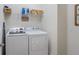 Functional laundry area with modern appliances and ample storage, making chores a breeze at 15241 Sunrise Grove Ct, Winter Garden, FL 34787