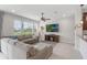 Comfortable living room featuring a large sectional sofa, ceiling fan, and modern entertainment center at 15241 Sunrise Grove Ct, Winter Garden, FL 34787