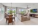 Inviting living room and dining area with modern decor, tile flooring, and a ceiling fan at 15241 Sunrise Grove Ct, Winter Garden, FL 34787