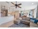 Open-concept living room featuring a modern sectional sofa and views of the kitchen and dining area at 15241 Sunrise Grove Ct, Winter Garden, FL 34787