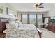 Comfortable main bedroom with a green accent wall, large bed, and nice view at 15241 Sunrise Grove Ct, Winter Garden, FL 34787