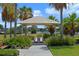 A covered picnic table surrounded by palm trees and lush landscaping; the perfect place for lunch at 15241 Sunrise Grove Ct, Winter Garden, FL 34787