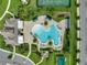 Aerial view of a unique, resort-style pool with ample seating and lush landscaping at 15241 Sunrise Grove Ct, Winter Garden, FL 34787
