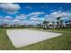 Sand volleyball court surrounded by a grassy area, palm trees and a covered picnic area at 15241 Sunrise Grove Ct, Winter Garden, FL 34787