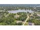 A captivating aerial view of a serene lake community with lush green trees and a charming neighborhood at 1601 Randolph St, Deltona, FL 32725