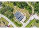 Aerial view of a residential home on a corner lot, surrounded by trees and well-maintained landscaping at 1601 Randolph St, Deltona, FL 32725