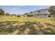 View of the home and the spacious backyard with fencing at 1601 Randolph St, Deltona, FL 32725