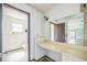 Vanity area featuring a large mirror, open access to toilet area, and access to other rooms at 1601 Randolph St, Deltona, FL 32725