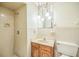 Clean bathroom with a shower, a sink with a wood cabinet, and modern fixtures at 1601 Randolph St, Deltona, FL 32725