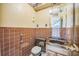 Bathroom featuring brown tile walls and unique lighting fixtures at 1601 Randolph St, Deltona, FL 32725