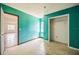 A vibrant bedroom featuring teal walls, a window for natural light, and a spacious closet at 1601 Randolph St, Deltona, FL 32725