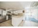 Kitchen with stainless steel appliances, white cabinetry and a view of the screened in porch at 1601 Randolph St, Deltona, FL 32725