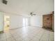 Open living area featuring a brick fireplace and tiled floor at 1601 Randolph St, Deltona, FL 32725