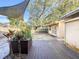 Backyard with a wooden deck, patio shade, and plants at 1840 Laurel Rd, Winter Park, FL 32789