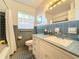 Bathroom featuring blue tiling and a window for natural light at 1840 Laurel Rd, Winter Park, FL 32789