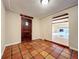 Charming foyer area featuring beautiful terracotta floors and arched doorway to the living room at 1840 Laurel Rd, Winter Park, FL 32789