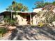 Stunning front exterior with paver driveway, mature landscaping, and a pergola detail at 1840 Laurel Rd, Winter Park, FL 32789