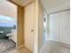 Hallway leading to the bathroom, showcasing neutral colors and closet space at 1840 Laurel Rd, Winter Park, FL 32789