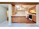 Kitchen features light wood cabinets, tile countertops, and is open to the carpeted area at 1840 Laurel Rd, Winter Park, FL 32789