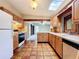 Traditional kitchen with light wood cabinets, tile countertops, stainless steel appliances, and a skylight at 1840 Laurel Rd, Winter Park, FL 32789