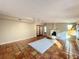 Living space featuring terracotta floors, a stucco fireplace, track lighting, and glass doors at 1840 Laurel Rd, Winter Park, FL 32789
