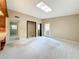 Bright and spacious living area with carpet and natural light, skylight, adjacent to kitchen at 1840 Laurel Rd, Winter Park, FL 32789
