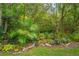 Lush backyard with tropical landscaping creating a private, natural oasis at 1933 Darlin Cir, Orlando, FL 32820