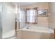 Well-lit bathroom featuring a walk-in shower and soaking tub beneath a window with privacy blinds at 1933 Darlin Cir, Orlando, FL 32820