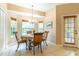 Breakfast nook featuring chandelier, tiled floor, and four windows providing ample natural light at 1933 Darlin Cir, Orlando, FL 32820