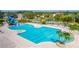 Spacious community pool with a splash pad, seating, and palm trees for relaxation at 1933 Darlin Cir, Orlando, FL 32820