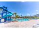 Large community pool with a water slide and plenty of lounge chairs on the deck at 1933 Darlin Cir, Orlando, FL 32820