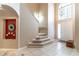 Elegant foyer with soaring ceilings, staircase and tile flooring that leads to the main living areas at 1933 Darlin Cir, Orlando, FL 32820