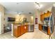 Open-concept kitchen with stainless steel appliances, center island, and views of the living area at 1933 Darlin Cir, Orlando, FL 32820