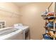 Bright laundry room with washer, dryer, and shelving for storage at 1933 Darlin Cir, Orlando, FL 32820