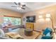 Bright living room featuring large window, ceiling fan, and comfortable seating at 1933 Darlin Cir, Orlando, FL 32820