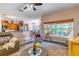 Open-concept living room with view of kitchen, breakfast nook, and outdoor seating area at 1933 Darlin Cir, Orlando, FL 32820
