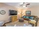 Comfortable living room with ceiling fan, plush carpet, and flat screen television at 1933 Darlin Cir, Orlando, FL 32820