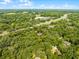 Aerial view of a property surrounded by lush greenery in a serene and private setting at 2 Rollingwood Trl, Deland, FL 32724