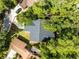 Overhead aerial view of the house surrounded by trees and a dark roof at 2 Rollingwood Trl, Deland, FL 32724