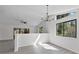 Dining area featuring modern light fixture, large windows and laminate flooring at 2 Rollingwood Trl, Deland, FL 32724