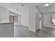 Bright entryway featuring a modern light fixture, large windows, and laminate flooring at 2 Rollingwood Trl, Deland, FL 32724