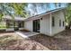 Rear exterior view shows the enclosed patio and access to the backyard at 2 Rollingwood Trl, Deland, FL 32724