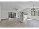 Bright living room featuring sliding glass doors, neutral walls, and light laminate flooring at 2 Rollingwood Trl, Deland, FL 32724